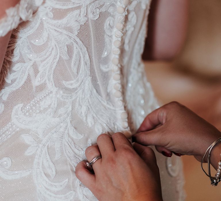 Bride wearing lace boned bodice wedding dress with off the shoulder detail 