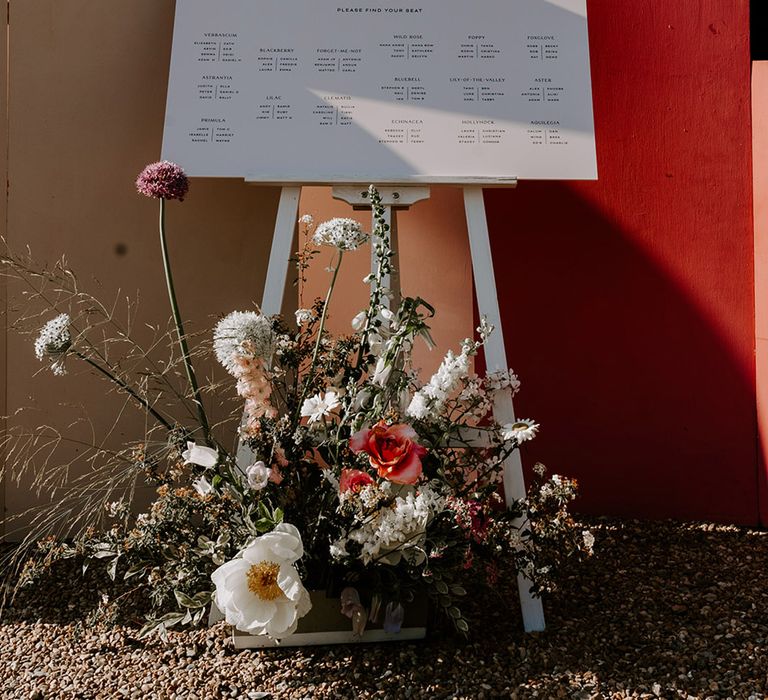 Wedding table plan signage with neutral wedding flowers 