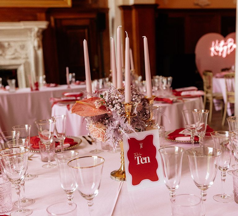 Red and pink wedding tablescape with bows and personalised place names 