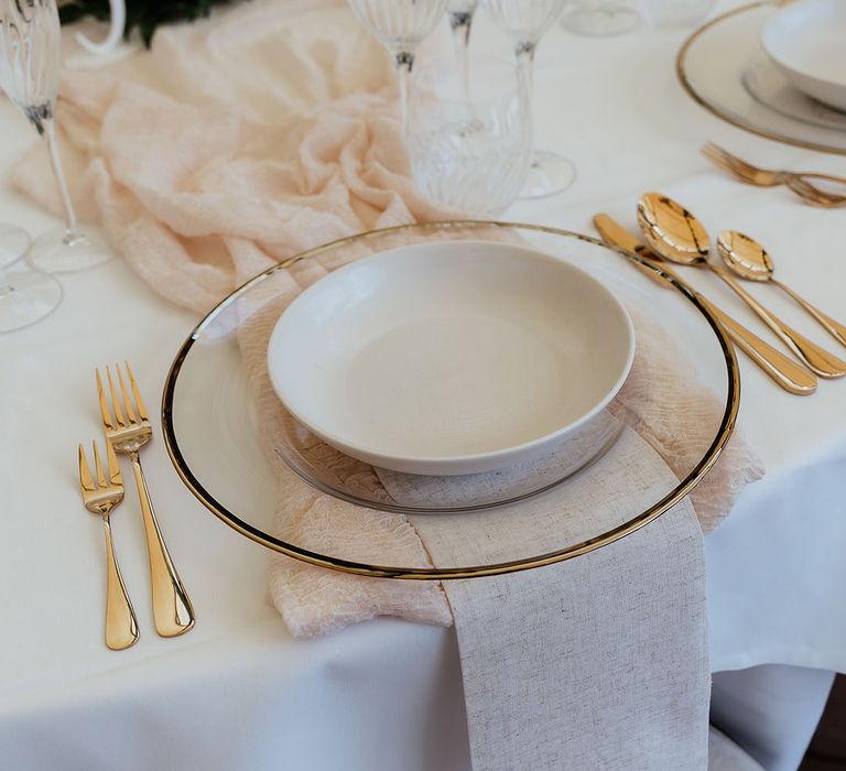 While, ivory and gold wedding table decorations with gold charger plates and cutlery for wedding place setting 