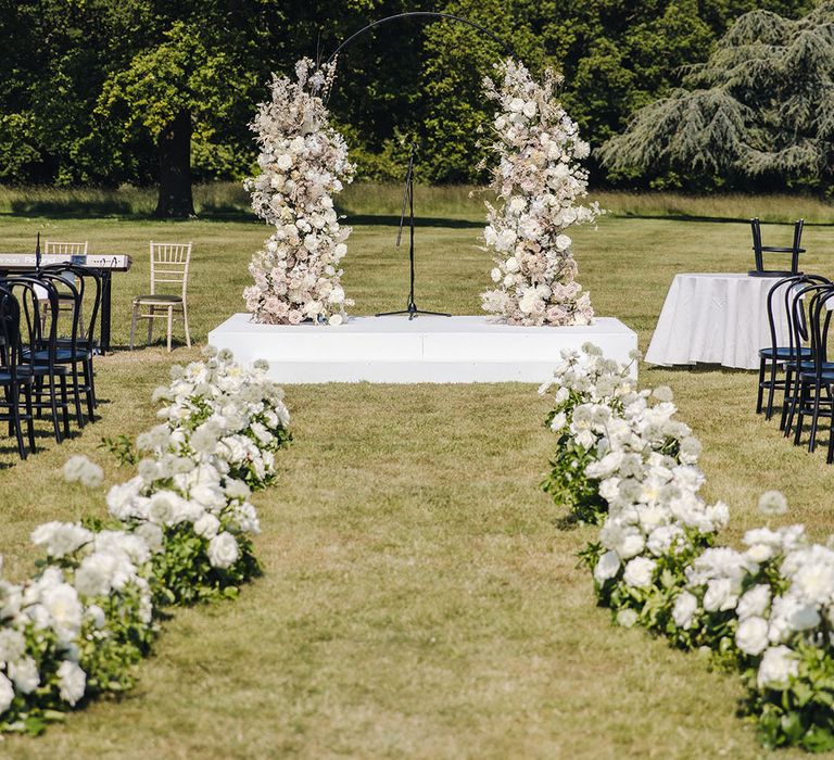 White flower column altar decoration for outdoor wedding ceremony at Offley Place 