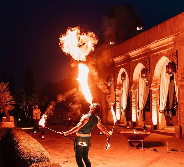 Fire breather performing at reception for fun wedding entertainment