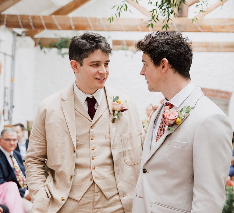 Groom and best man at barn wedding standing at the altar 