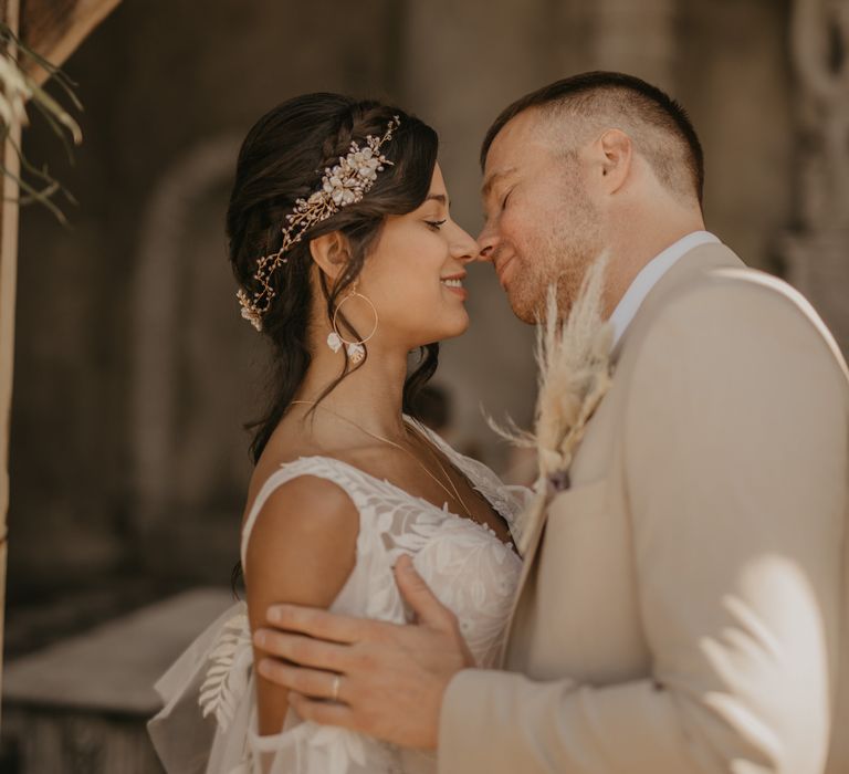 Bride and groom kissing at intimate wedding ceremony 