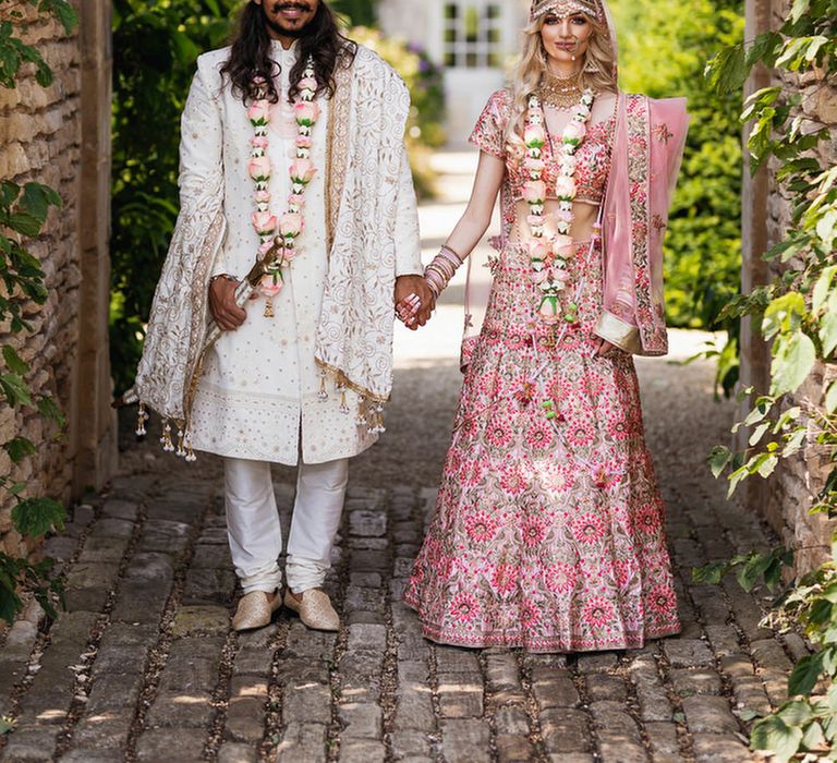 Bride and groom in Indian wedding outfits at The Lost Orangery