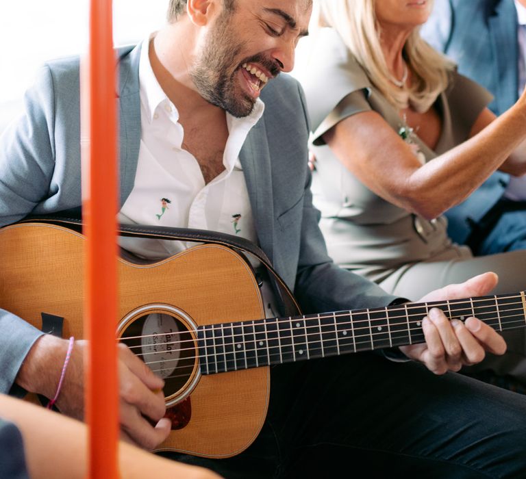 Wedding party singing on the way to the reception on London bus