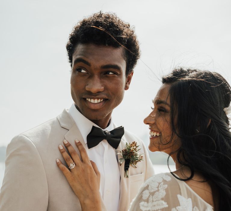 Bride with pale grey wedding nails matching the grooms jacket 