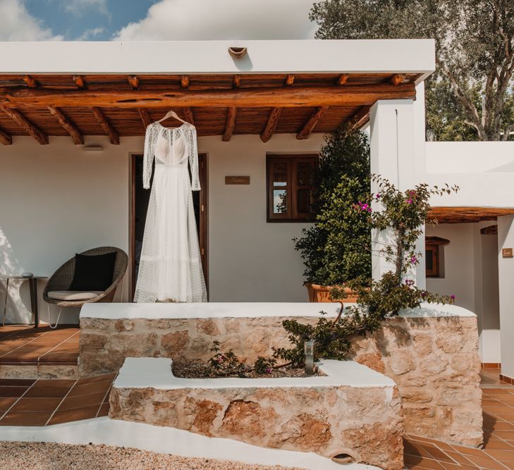 Marylise Bridal gown hanging up outside a Spanish villa 