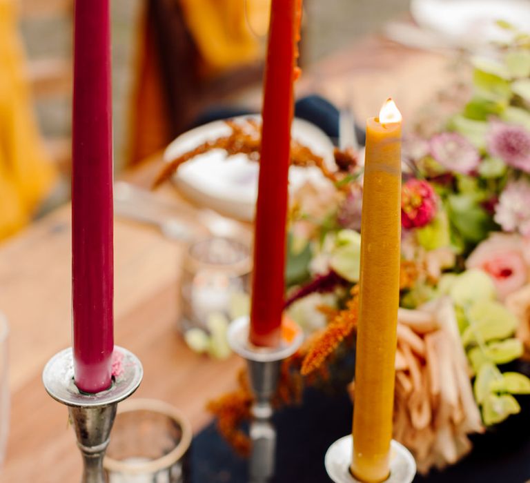 Red, yellow and pink tapered candlesticks for an intimate wedding dinner at a Tuscany elopement