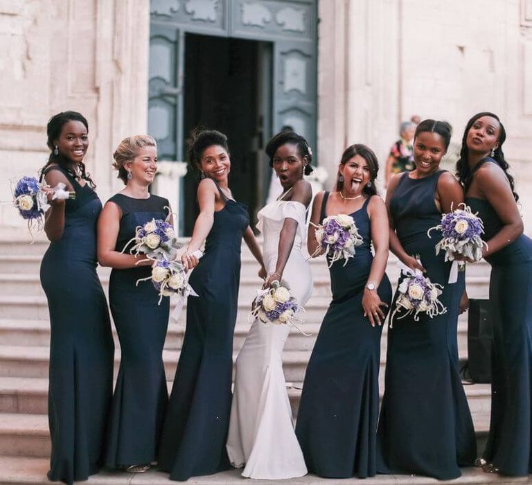 Group of bridesmaids wearing floor length, sleeveless form fitting navy bridesmaid dresses, with assorted styles of neckline | Peridot Official Dresses | Ivan L'Astorina Photography