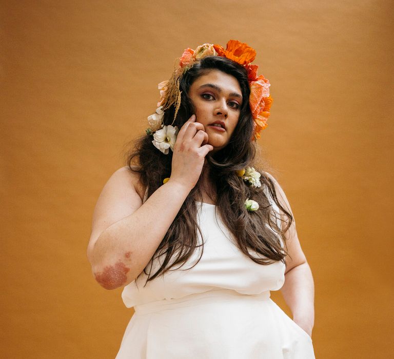 Bride wearing simple Paper To Lace wedding separates with hand painted illustrations, wearing orange flowers in her hair