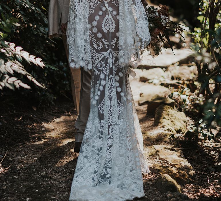 Boho bride in a Rue de Seine wedding wedding dress with bell sleeves and puddle train 