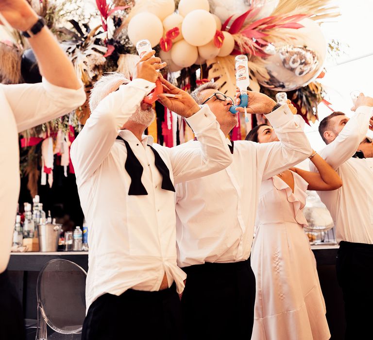 Wedding guests share a drink during reception