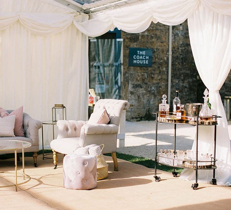 Outdoor seating area complete with bar cart for outdoor wedding ceremony during summer at Mapperton House