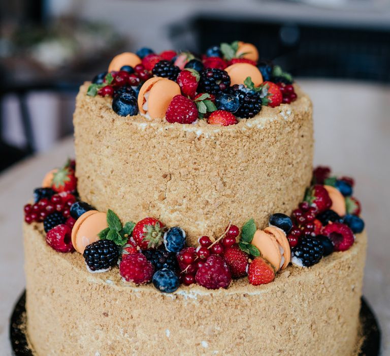 Two tier wedding cake complete with crumb coating and fruit decor