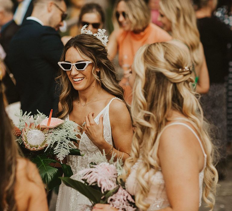 Bride wears sunglasses on her wedding day outdoors