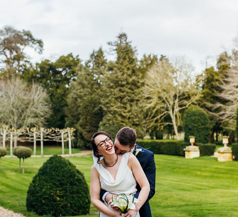 Bride & groom embrace outdoors