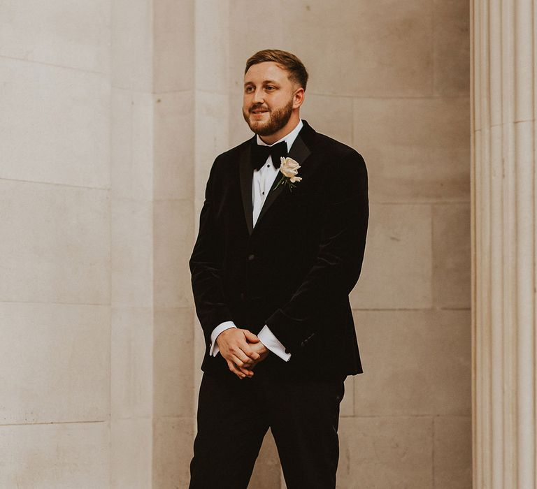 Stylish groom in a tuxedo and bow tie at Old Marylebone Town Hall wedding