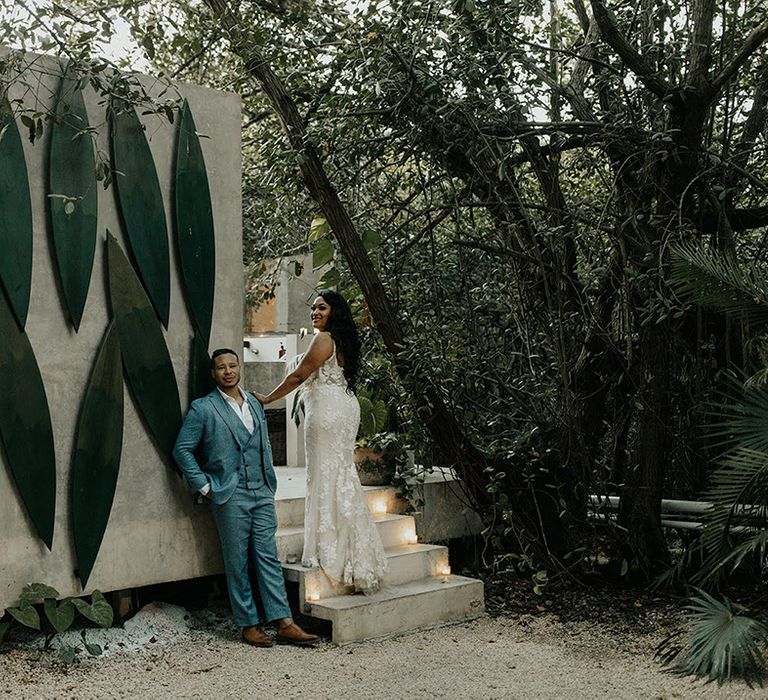 Bride and groom pose in Tulum for outdoor destination wedding and traditional Mayan ceremony