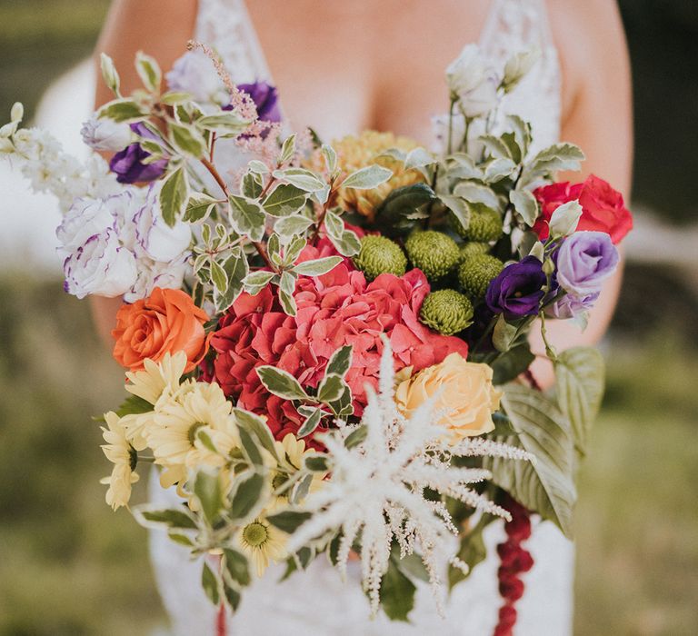 Pink, yellow, purple colourful flowers for wedding bouquet with garland