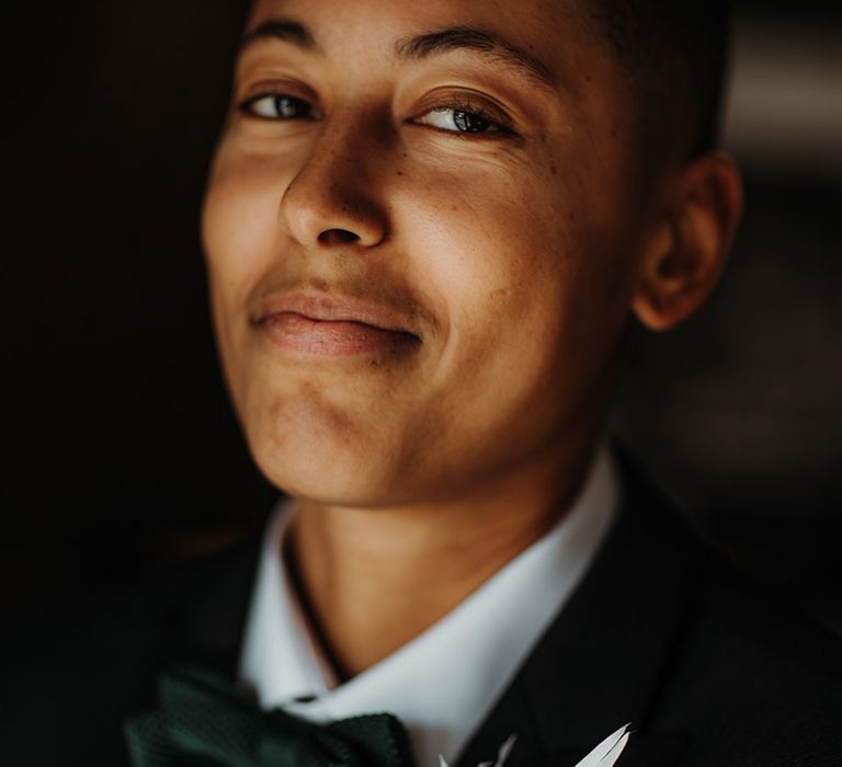 LGBTQI+ person with natural makeup and bow tie 