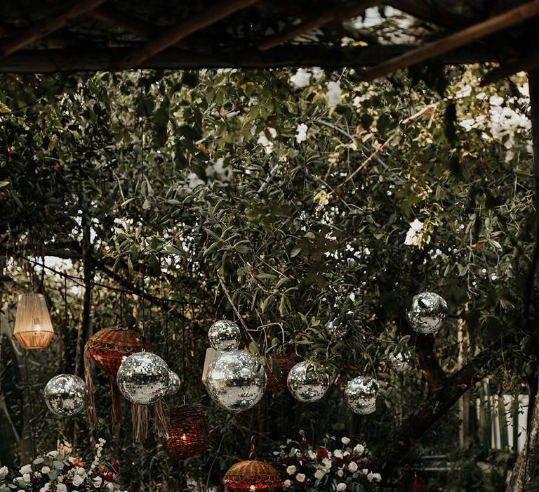 Mayan jungle wedding with sweetheart table under a disco ball installation