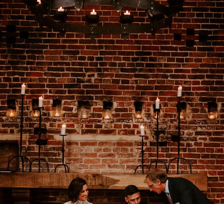 Bride and groom sign the register with one of their sons next to them