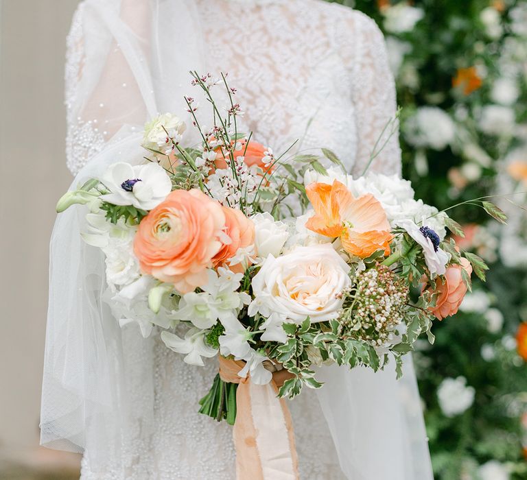 white and peach wedding bouquet with roses, ranunculus, anemones and Icelandic poppies 