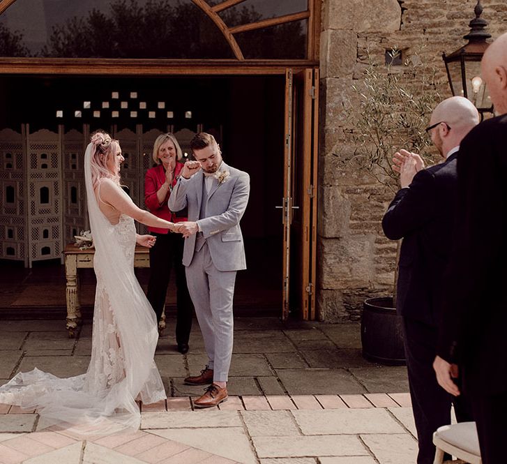 Bride & groom during outdoor wedding ceremony at Oxleaze Barn