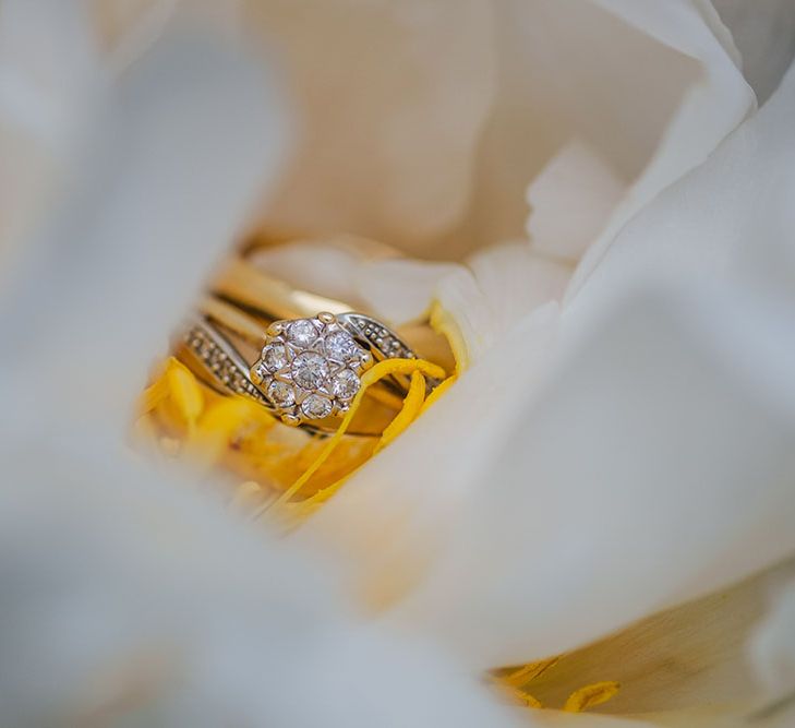 Diamond ring with floral feel sits in flower 