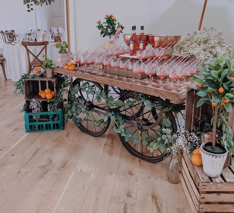 Aperol Spritz cocktail bar are on rustic wooden cart 