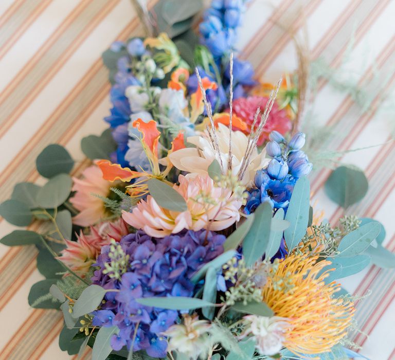 Colourful floral bouquet tied with yellow and blue silk ribbon 