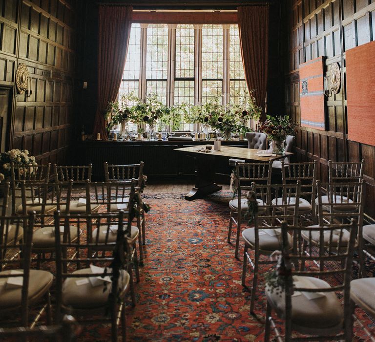 Askham Hall ceremony room decorated with chairs and rustic wedding flowers for intimate wedding