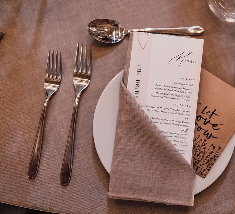 Traditional black and white wedding menu stationery with grey napkin and tablecloth with seed wedding favours 