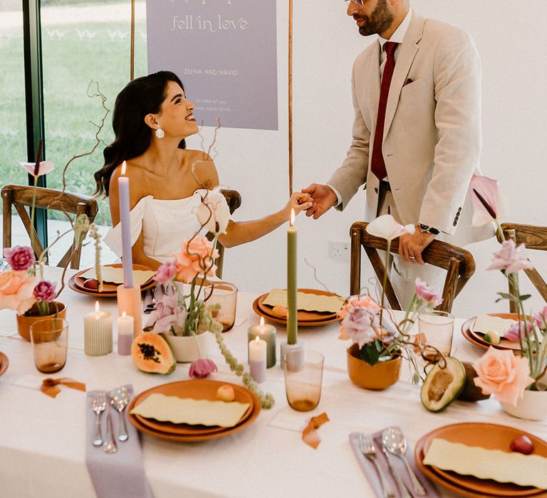 wedding reception decor with colourful flowers and taper candles at Chapel House Estate 