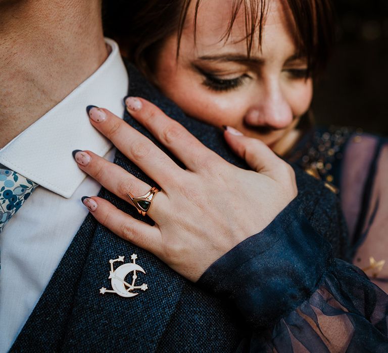 Bride in black French tip wedding nails with gold star details and unique black stone engagement ring and bespoke wedding ring 