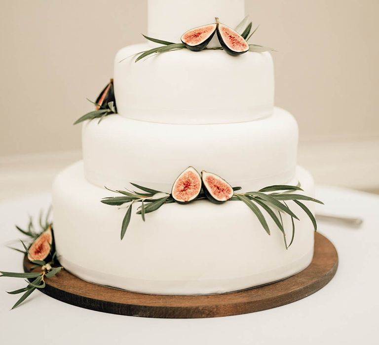 Four tier iced wedding cake with figs 