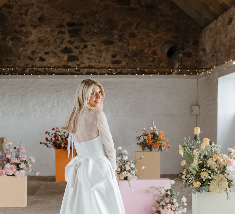 Bride wears a Jessica Bennett gown with bow detail on the back 