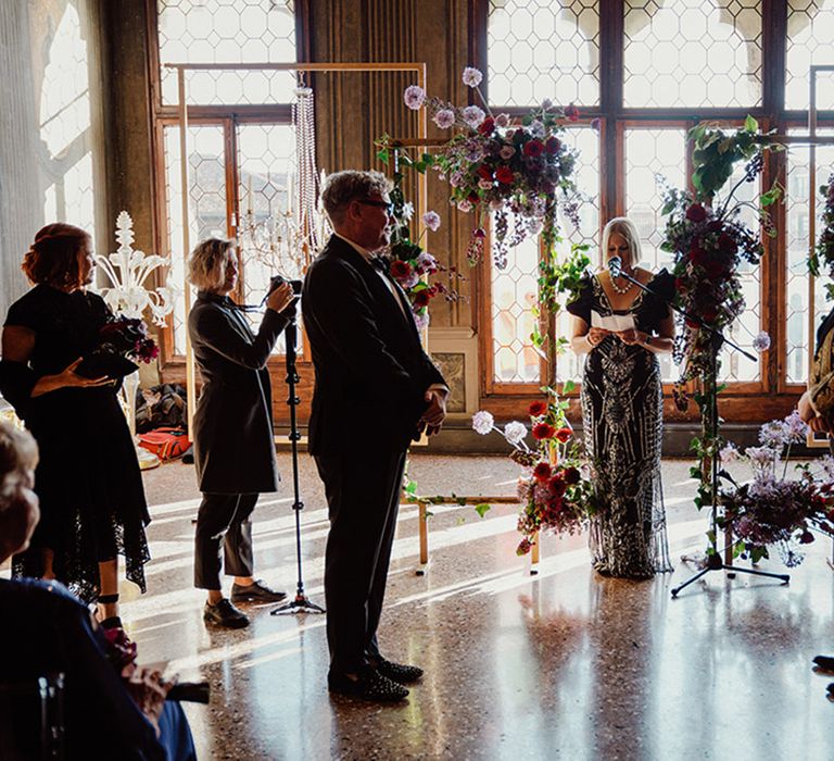 Ca'Sagredo hotel in Venice ceremony room with the two grooms at their same sex wedding ceremony 