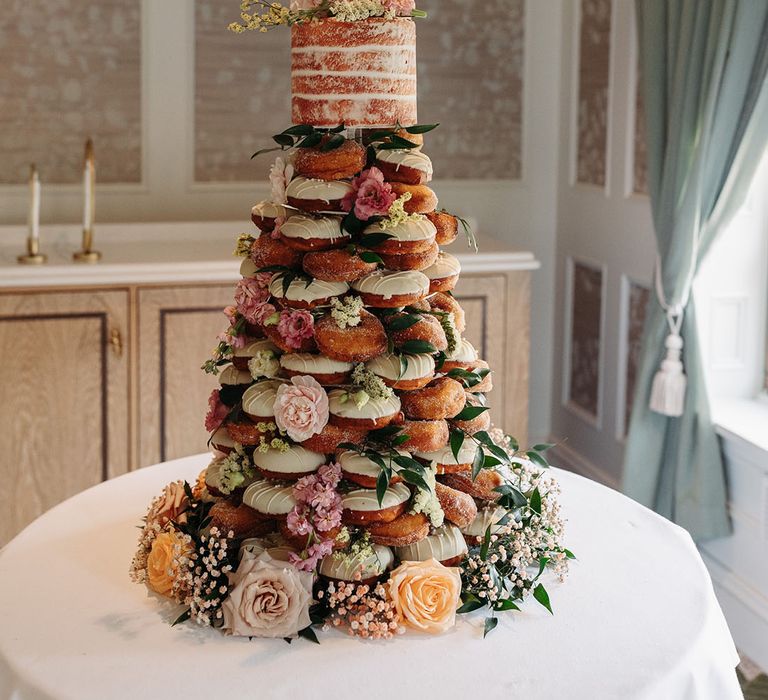 Sassy's Sugar Doughnuts created a doughnut tower for summer weddings with roses and gypsophila flowers 