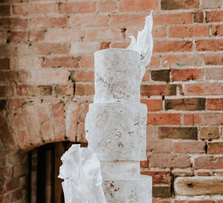 Epic three tier white wedding cake with unique stone effect 