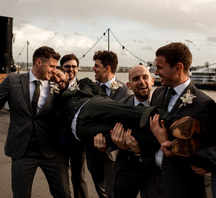 Groomsmen in London with disco ball wedding decor