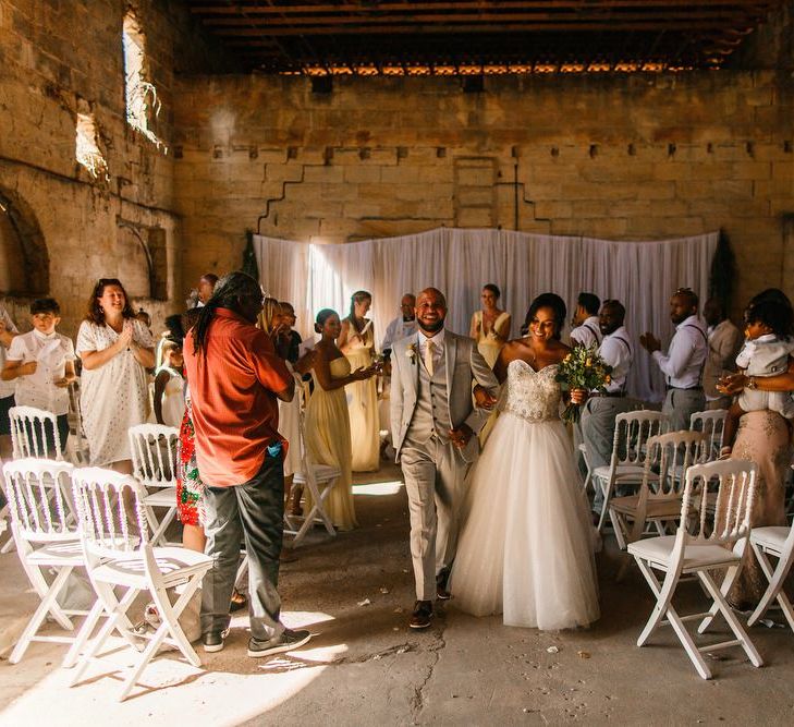 Bride and groom walk up the aisle