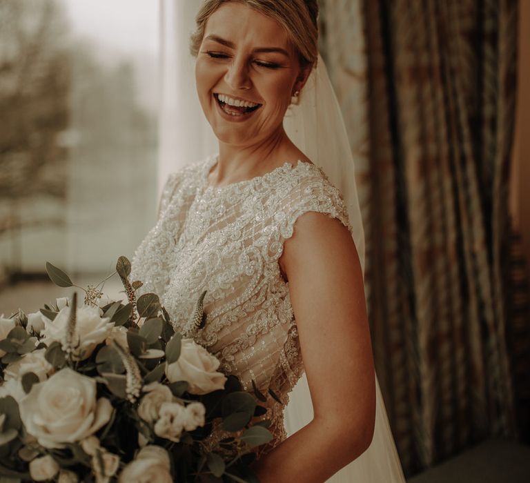 Bride laughing on the morning of her Inn on the lake wedding