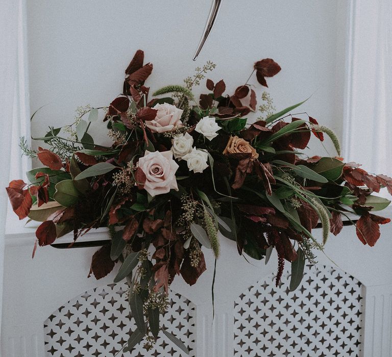 Wedding flower arrangement with foliage and roses 