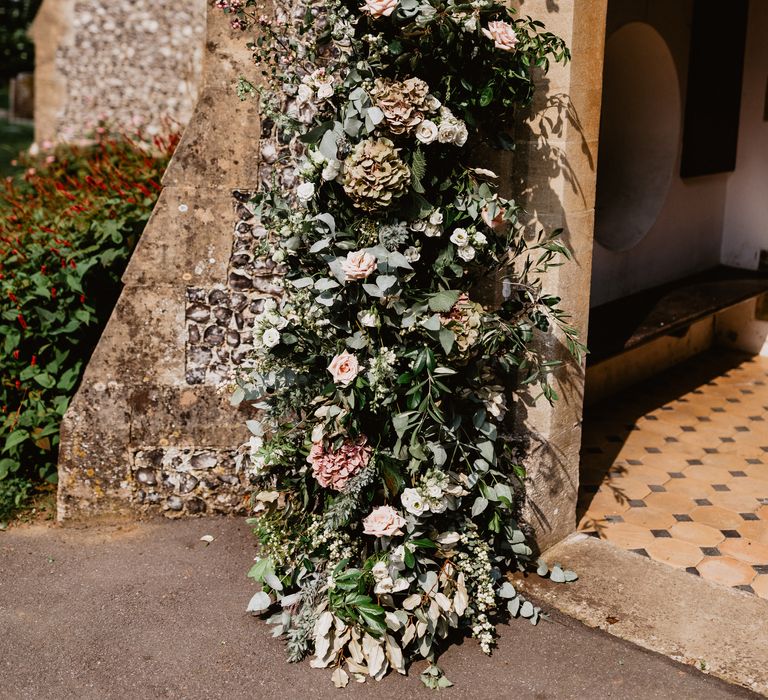 Florals outside church archway 