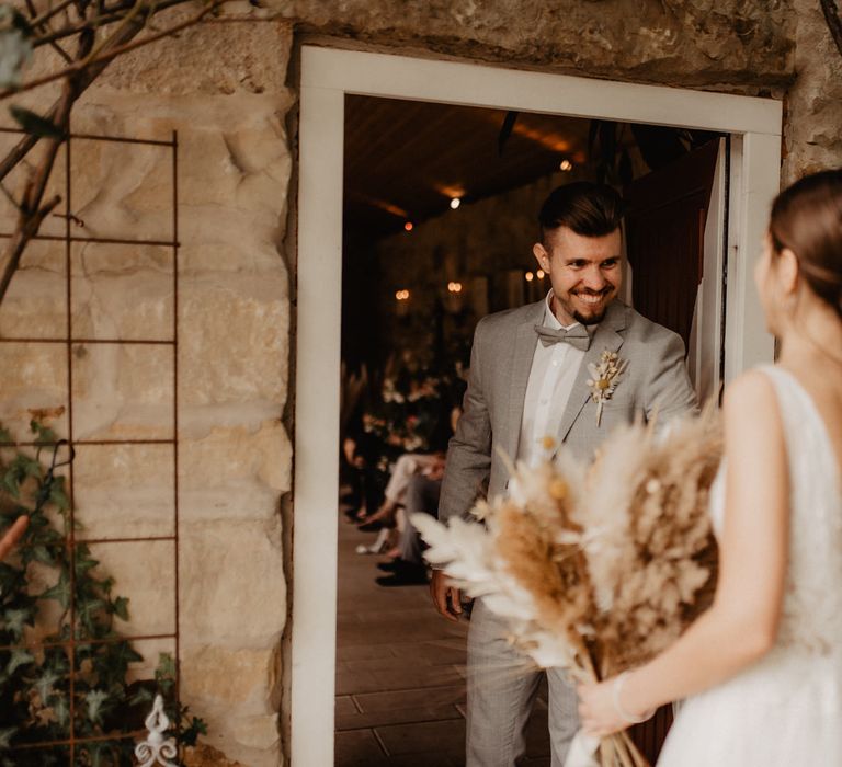 Groom sees bride for the first time at boho wedding