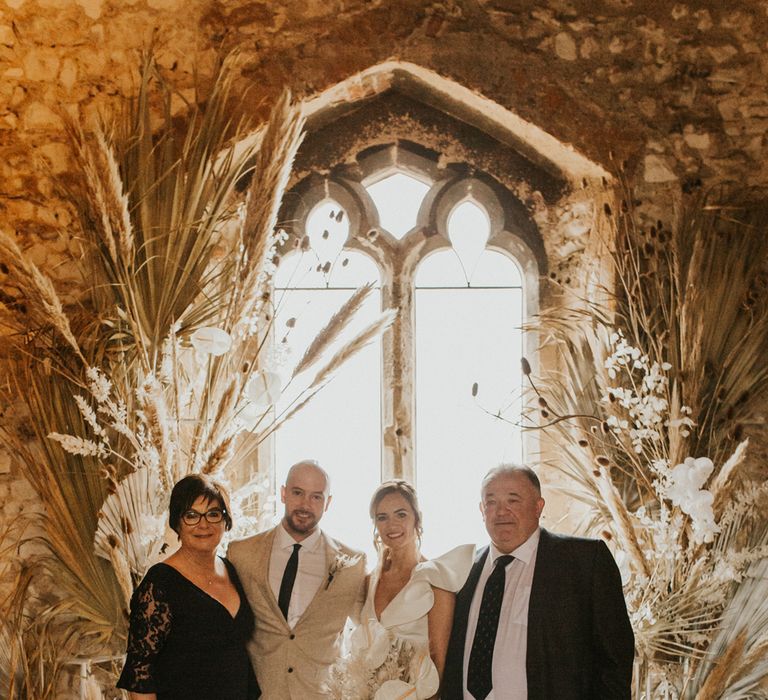 Portrait of the bride and groom with their parents 