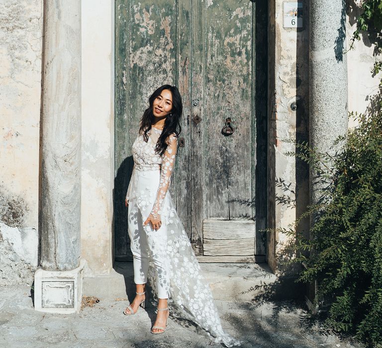 Bride in wedding jumpsuit with appliqué detail 