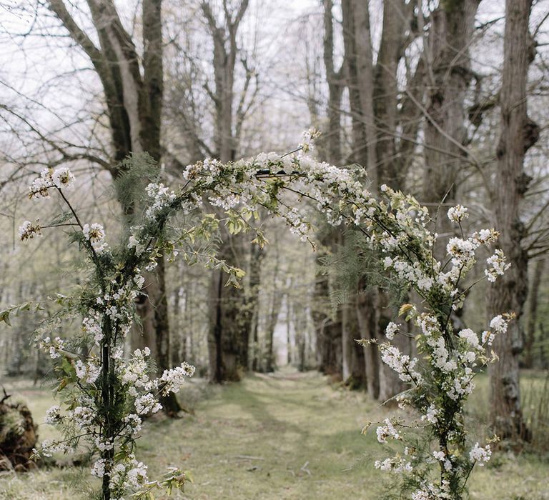 Flower arch in the woodland at Chateau de la Ruche